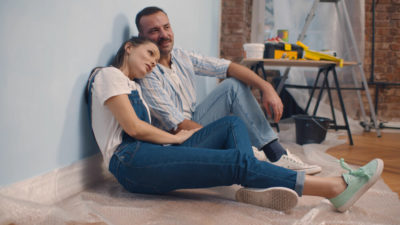 couple sitting in painted room
